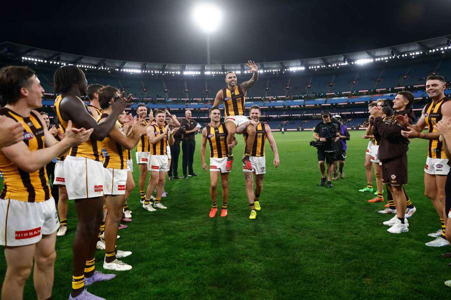 Hawthorn's Jarman Impey is chaired off after winning his 200th AFL game. 