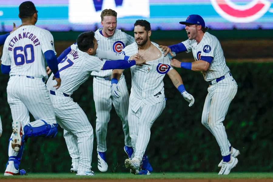 Chicago Cubs' Mike Tauchman celebrates with teammates after his walk-off single against the Cardinals