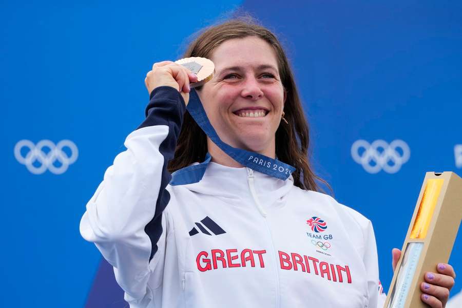 Kimberley Woods, bronze medalist in the women's kayak single, poses on the podium