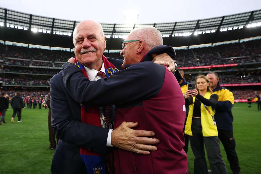 Brisbane coach Chris Fagan embraces good friend and coaching idol Leigh Matthews.
