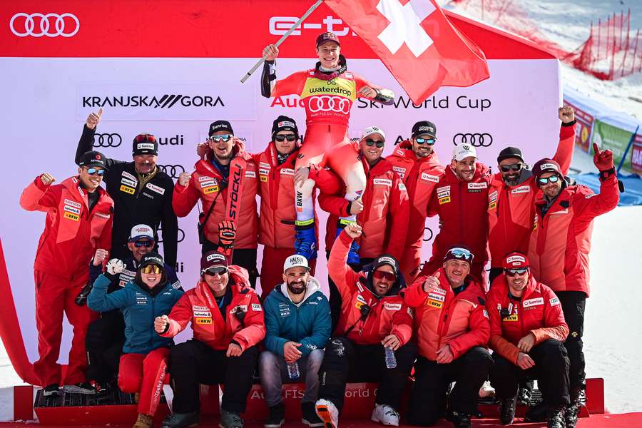 Switzerland's Marco Odermatt celebrates with his team