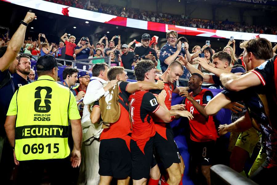Austria's Sasa Kalajdzic celebrates scoring their third goal with teammates