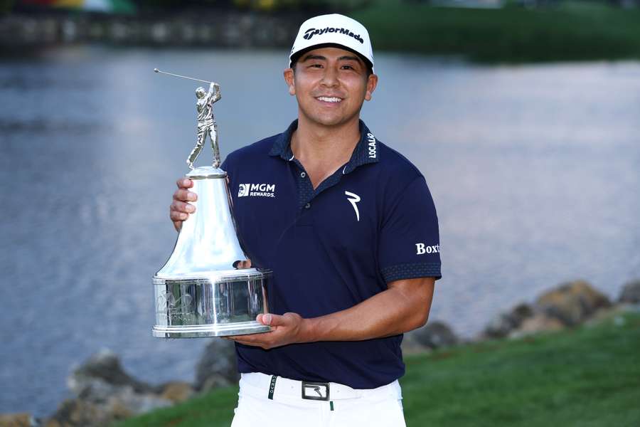 Kurt Kitayama of the United States celebrates with the trophy