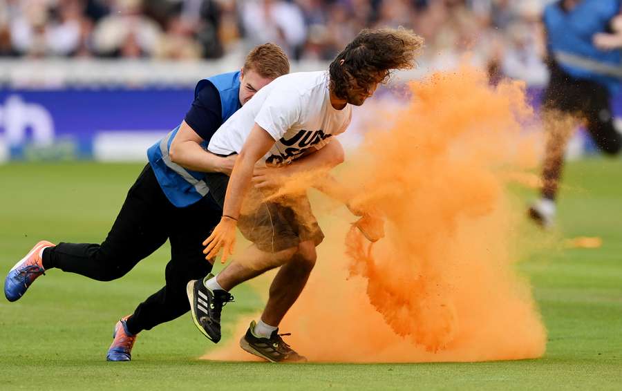 A 'Just Stop Oil' protester is tackled by security during Day One of The Ashes at Lord's
