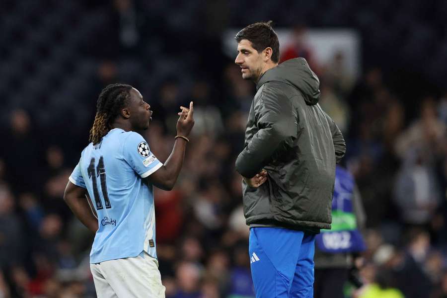 Manchester City's Jeremy Doku and Real Madrid's Thibaut Courtois after the match