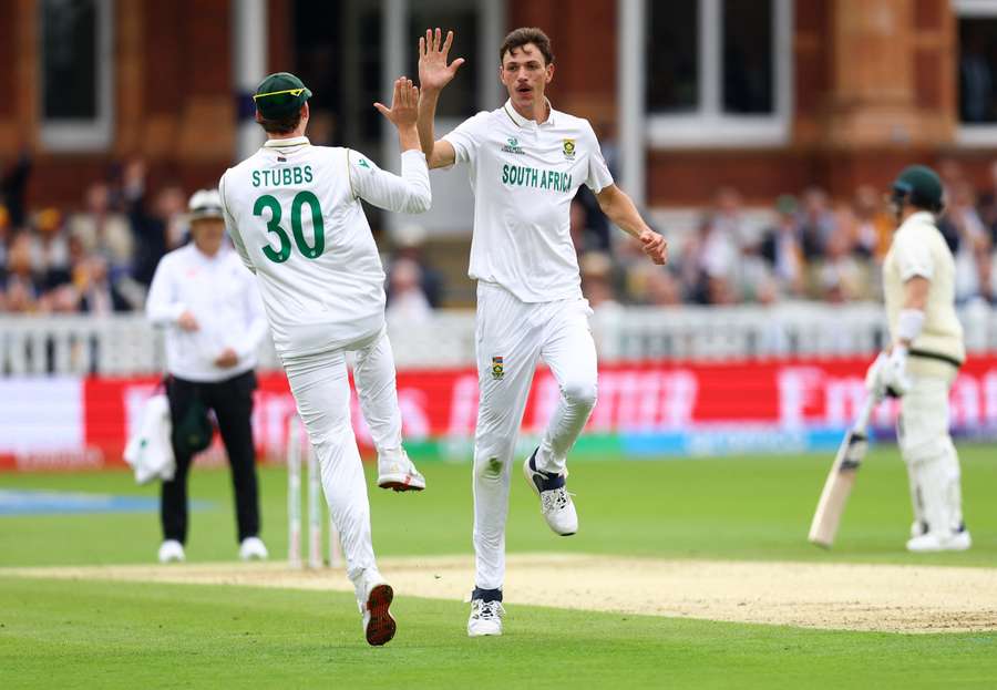 South Africa's Marco Jansen celebrates with Tristan Stubbs after taking the wicket of Australia's Travis Head, caught out by Kyle Verreynne