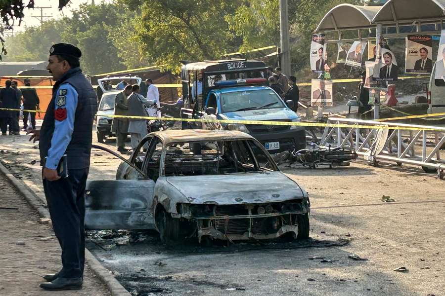 Police inspect a damaged car following a suicide blast outside a court in Islamabad on Tuesday. Police inspect a damaged car following a suicide blast outside a court in Islamabad on Tuesday.