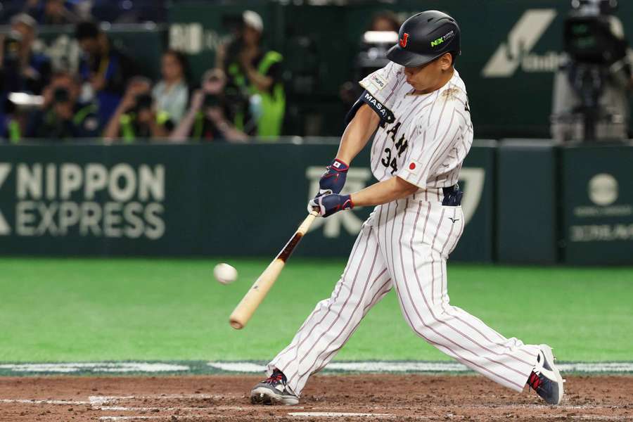 Masataka Yoshida sends the ball into the stands for Japan Masataka Yoshida sends the ball into the stands for Japan