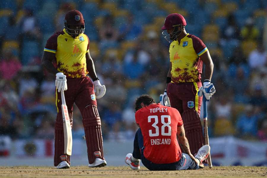 England's Reece Topley lies on the ground after bowling during the first T20 international against the West Indies