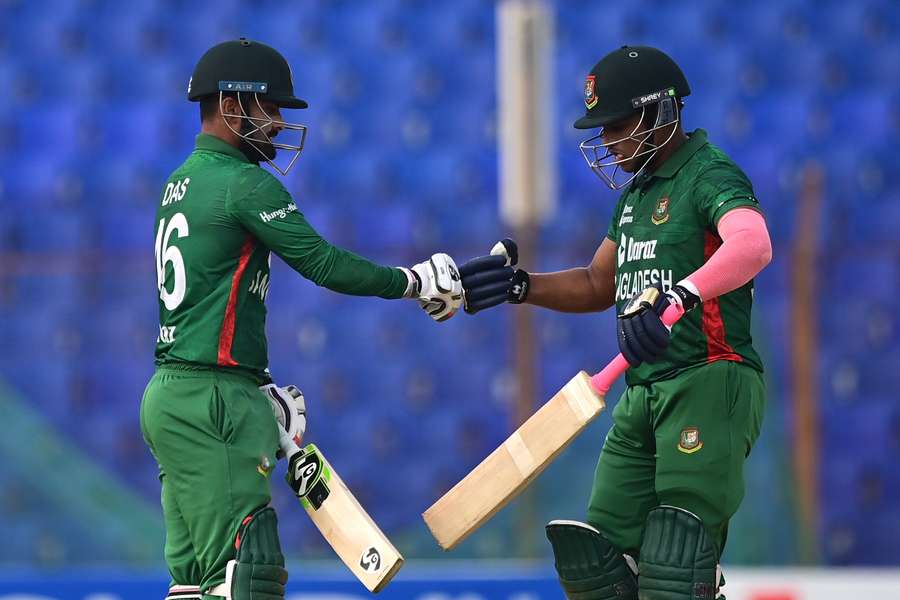 Bangladesh's Liton Das (L) and Rony Talukdar bump their fists