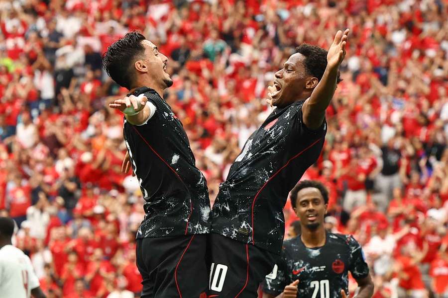 Jonathan David celebrates scoring Canada's third goal with teammate Stephen Eustaquio