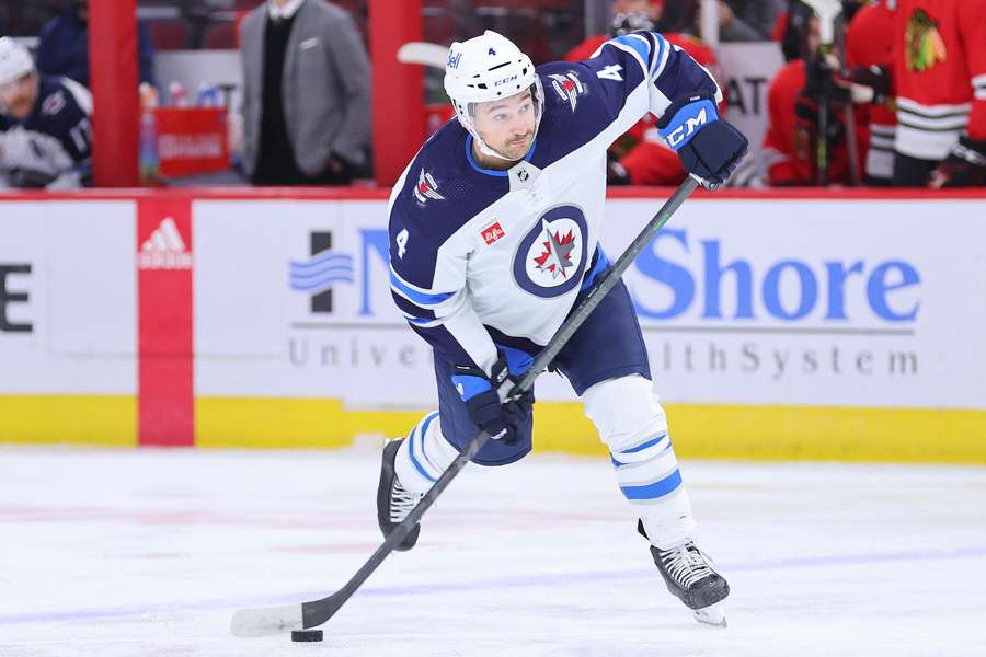 Winnipeg Jets sign defenseman Neal Pionk taking a shot against the Chicago Blackhawks