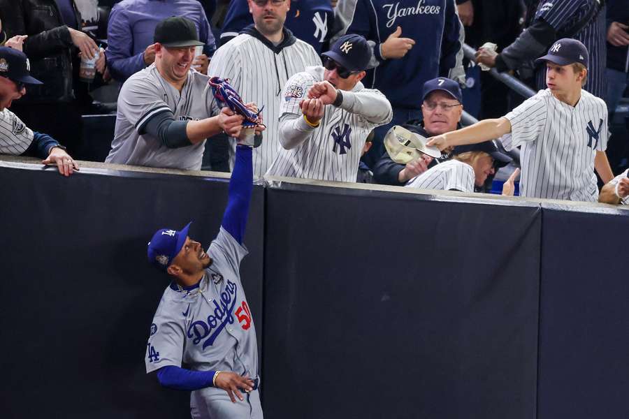 Mookie Betts attempting to catch a ball during the 2024 World Series.