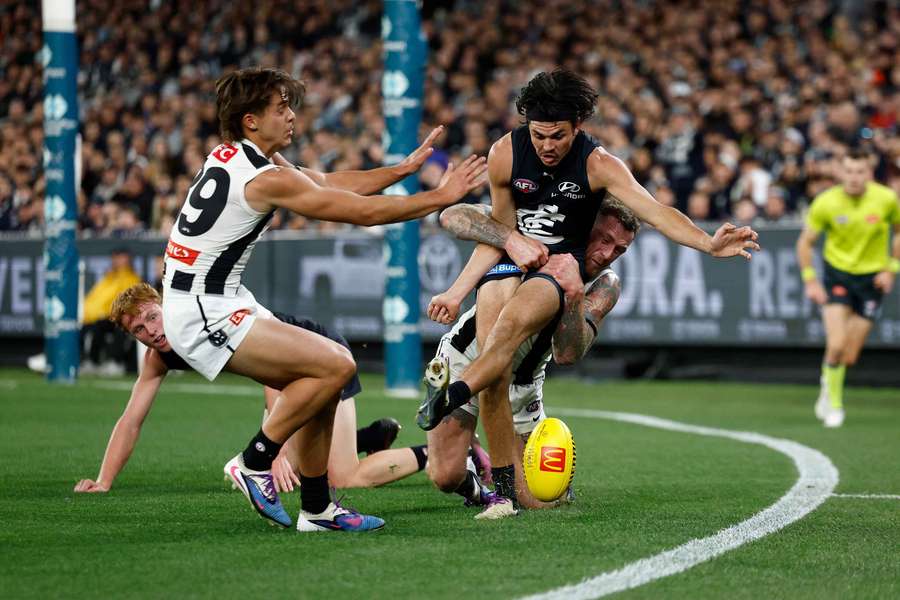 Elijah Hollands is tackled by Collingwood's Tim Membrey last Thursday night.