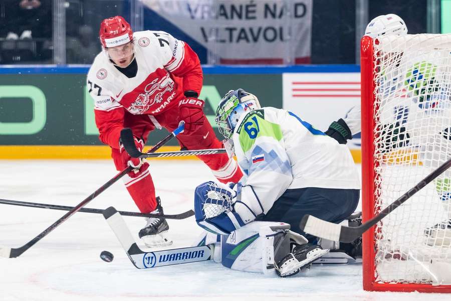 Denmark's Mathias From, left, challenges Slovenia's goaltender Lukas Horak, during the game Denmark's Mathias From, left, challenges Slovenia's goaltender Lukas Horak, during the game