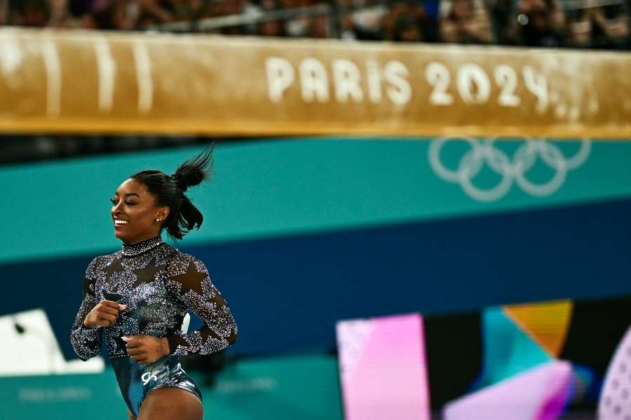 Biles competing in the balance beam event of the artistic gymnastics women's qualification