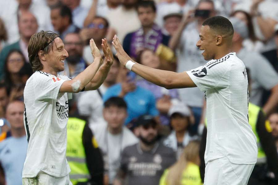 Kylian Mbappe celebrates with the departing Luka Modric