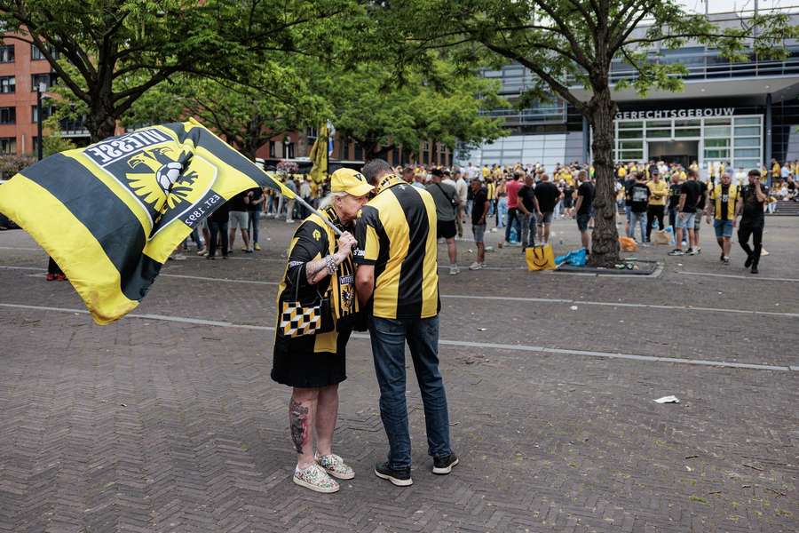 A pair of Vitesse fans listen to summary proceedings about the club's licence outside the court in Utrecht 