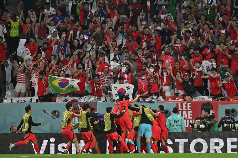 South Korea's players celebrate their victory during the Qatar 2022 World Cup Group H football match between South Korea and Portugal