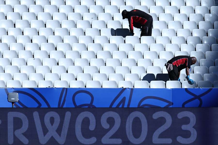 Workers clean stadium seats at the Stade de France in Saint-Denis