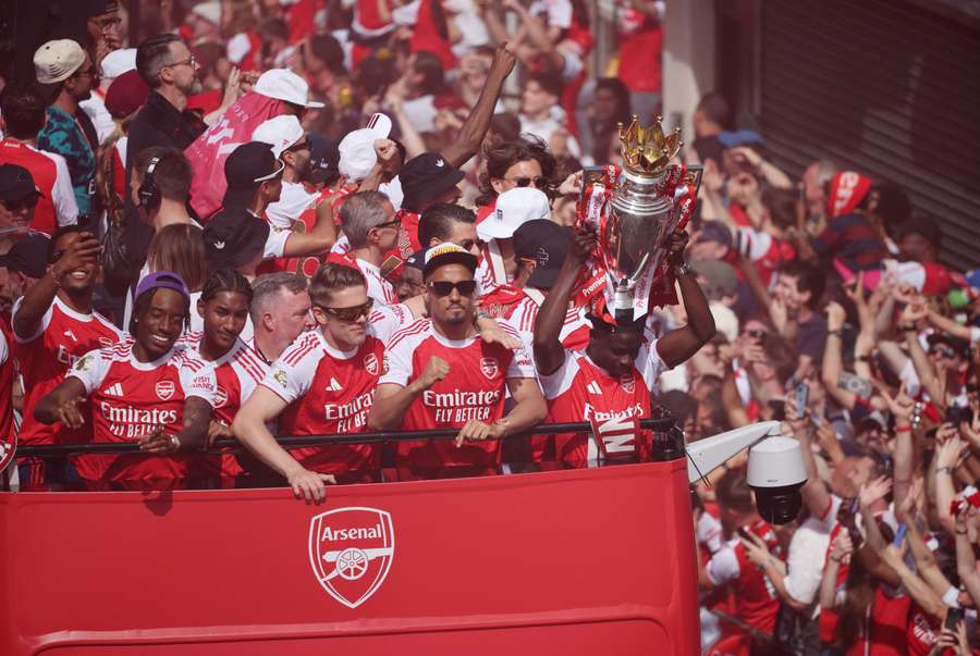 Arsenal's players take in their supporters during the parade Arsenal's players take in their supporters during the parade