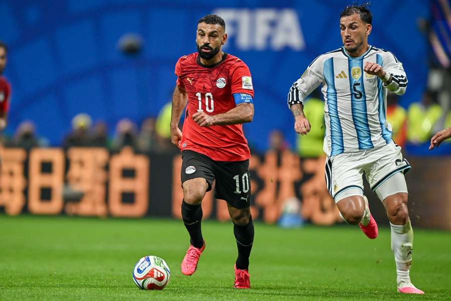 Mohamed Salah battles for possession with Leandro Paredes of Argentina during the World Cup  Round of 16 clash