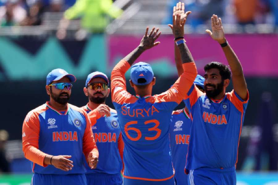 India's Jasprit Bumrah celebrates with teammates after taking the key wicket of Pakistan's Babar Azam