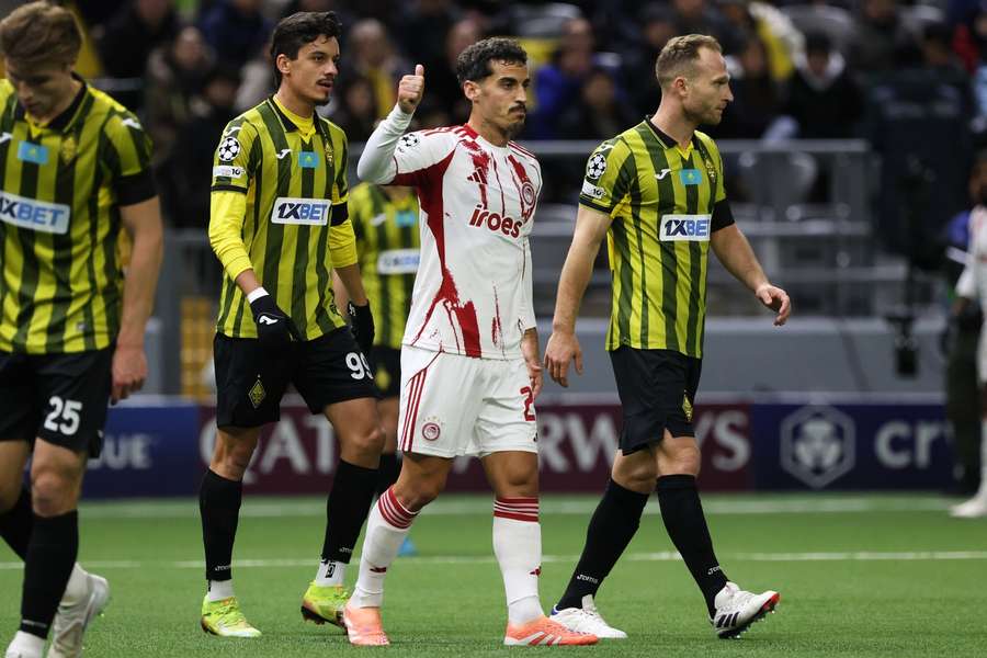 Olympiacos' Chiquinho (C) gestures during their clash