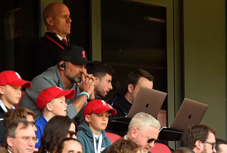 Liverpool's German manager Jurgen Klopp (2L) watches from the stands during the English Premier League football match between Liverpool and Aston Villa at Anfield