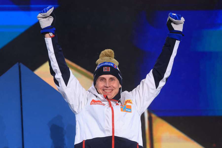 Norway's Simen Hegstad Krueger celebrates on the podium