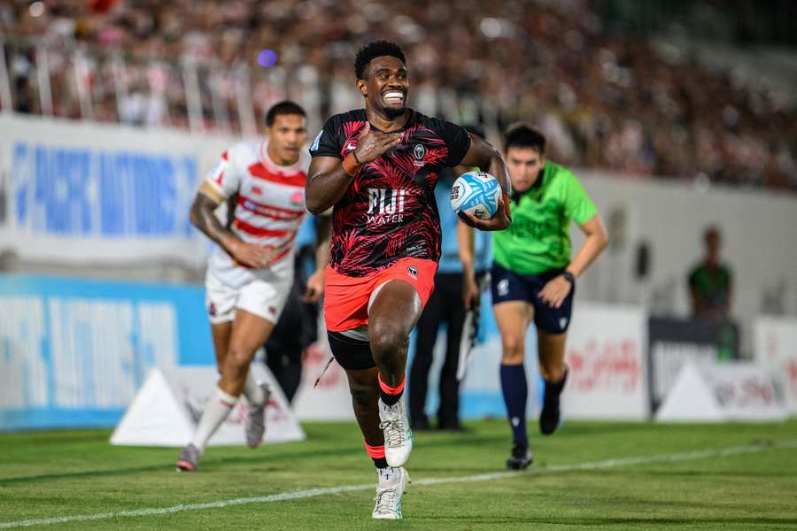 Fiji's Vuate Karawalevu runs to score a try during the Pacific Nations Cup final. 