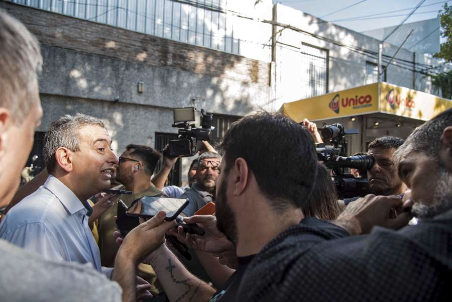 Pablo Javkin, mayor of Rosario, speaks with the press in front of a supermarket belonging to the wife of Argentine football star Lionel Messi