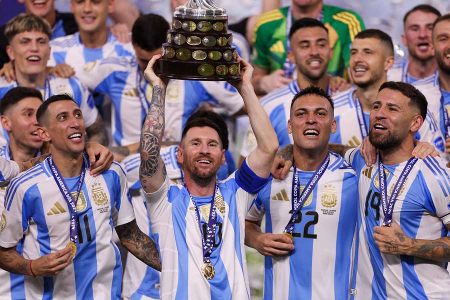 Messi holds the trophy aloft