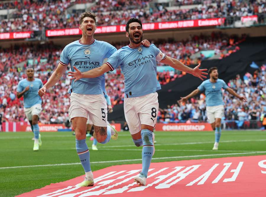 Manchester City defender John Stones (L) celebrates with goalscorer Ilkay Gundogan