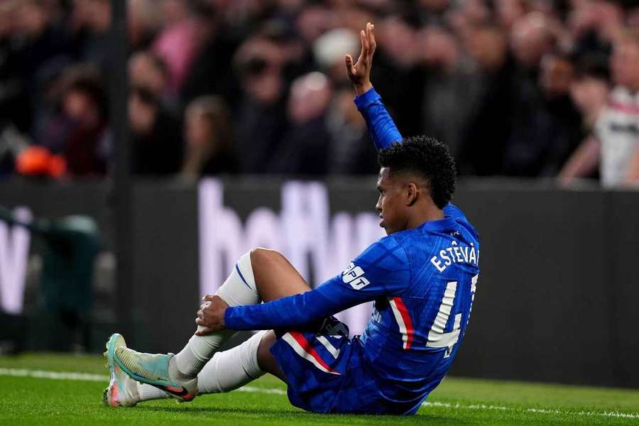 Estevao holds his leg after picking up an injury against Man Utd