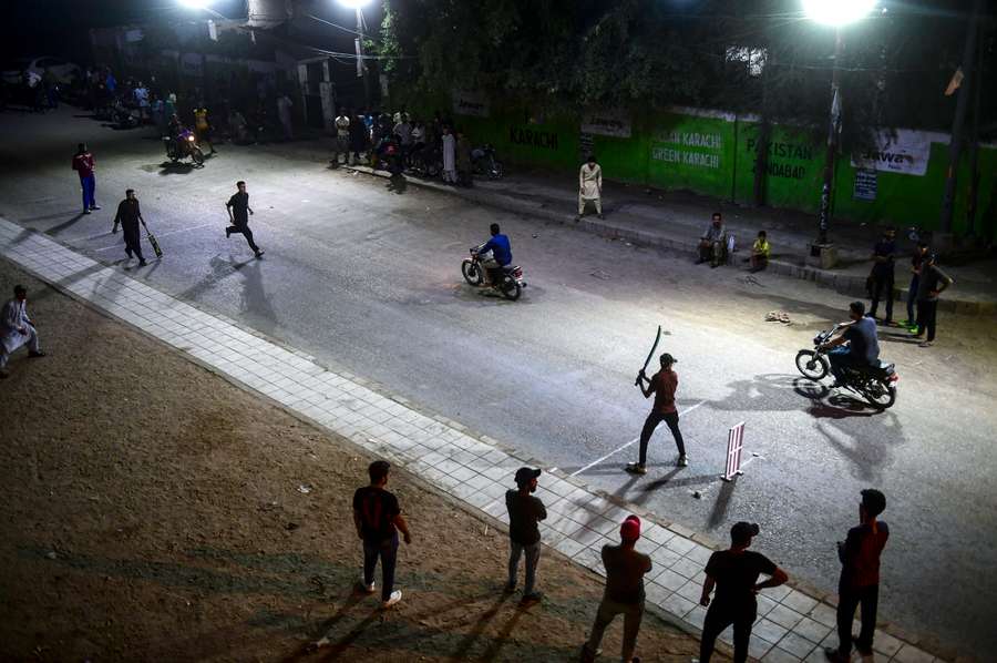 After midnight during Ramadan, makeshift floodlights transform a central Karachi basketball court into an urban cricket arena