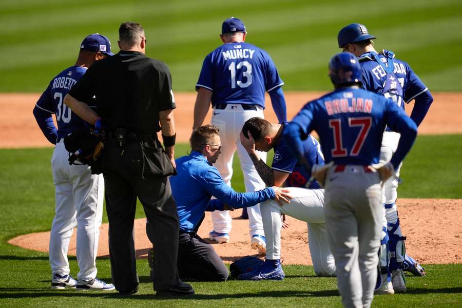 LA Dodgers pitcher Bobby Miller reacts after being hit by a line drive from Chicago Cubs' Michael Busch