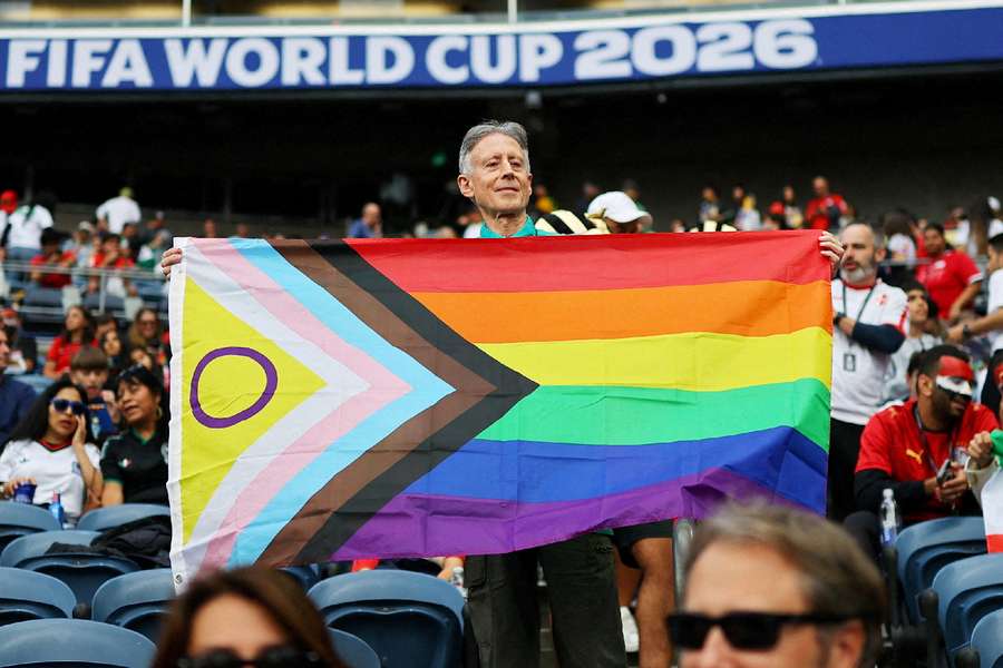 Activist holds up Pride flag during the 'Pride match'