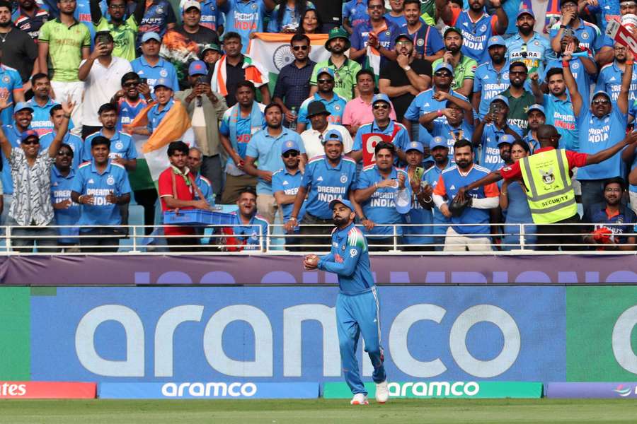 Kohli celebrates after taking a catch to dismiss Pakistan's Khushdil Shah
