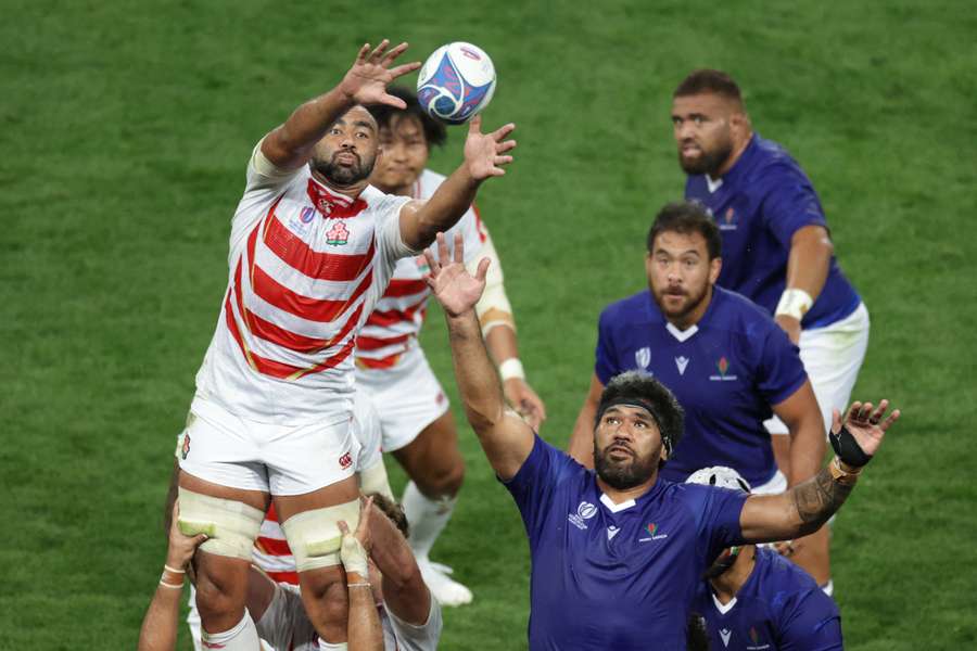 Japan's blindside flanker Michael Leitch (L) catches the ball from a line out ahead of Samoa's lock Brian Alainu'uese