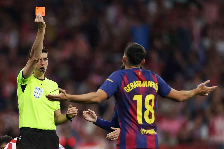 Barcelona's Gerard Martin is shown a red card by referee Mateo Busquets