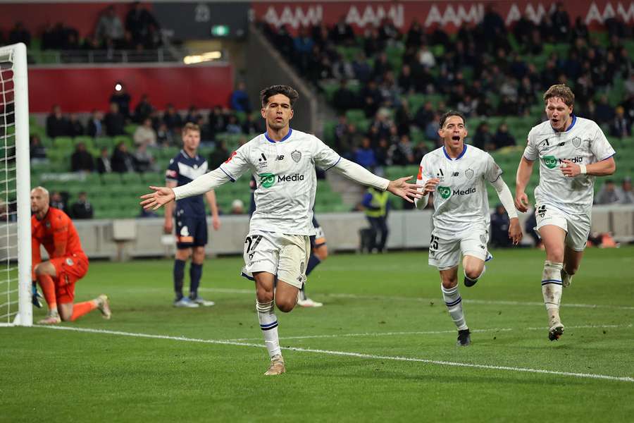 Auckland FC's Logan Rogerson wheels away in celebration after scoring the winning goal of their semi-final first leg.