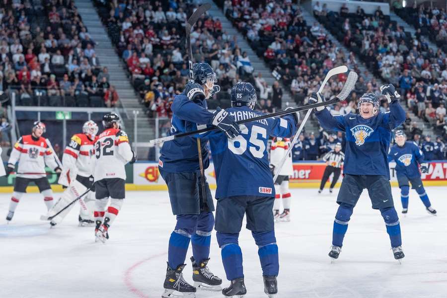 Finland players celebrate their fourth goal of the game