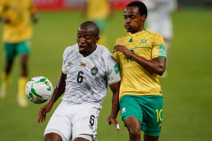 South Africa's Percy Tau (right) fights for the ball with Zimbabwe's Gerald Takwara during their 2022 World Cup qualifier in Johannesburg.
