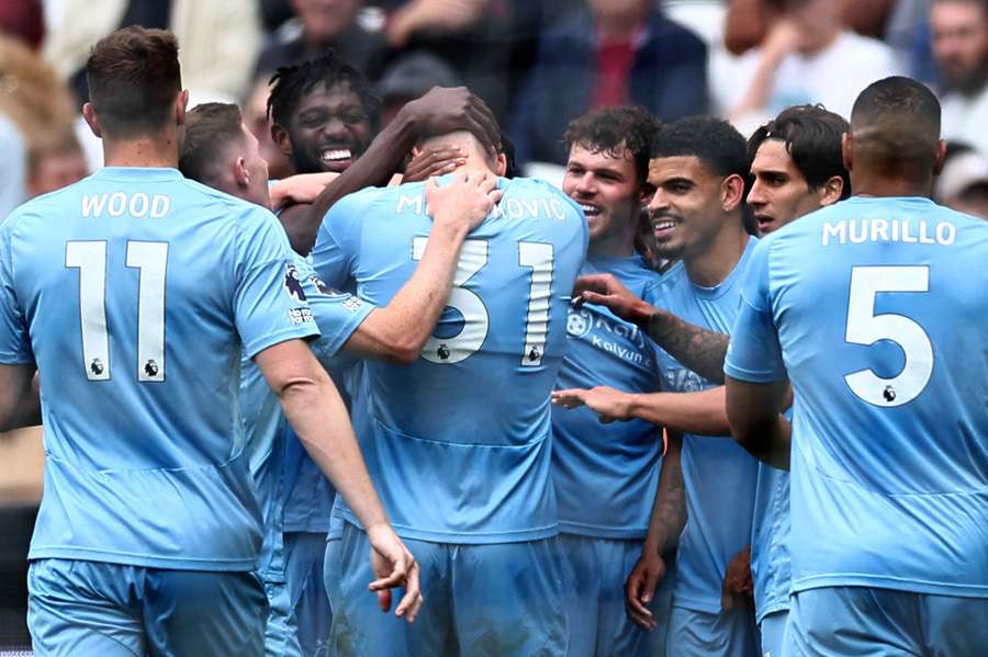 Nikola Milenkovic is mobbed by team-mates after scoring Forest's second goal