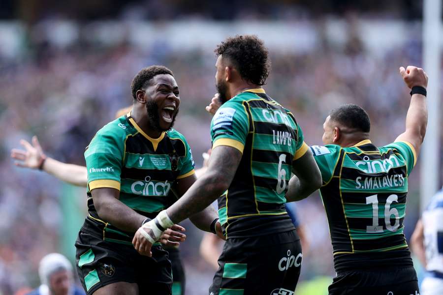 Northampton's Emmanuel Iyogun and Courtney Lawes celebrate victory in the Premiership final