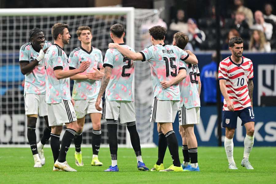 Belgium celebrate next to Christian Pulisic