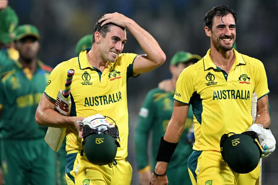 Australia captain Pat Cummins and Mitchell Starc (R) walk back to the pavilion after their semi-final win over South Africa