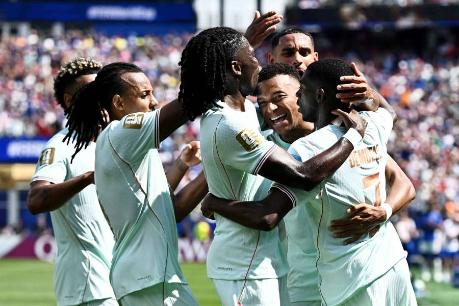France's Ousmane Dembele celebrates scoring their third goal with teammates, completing his hat-trick