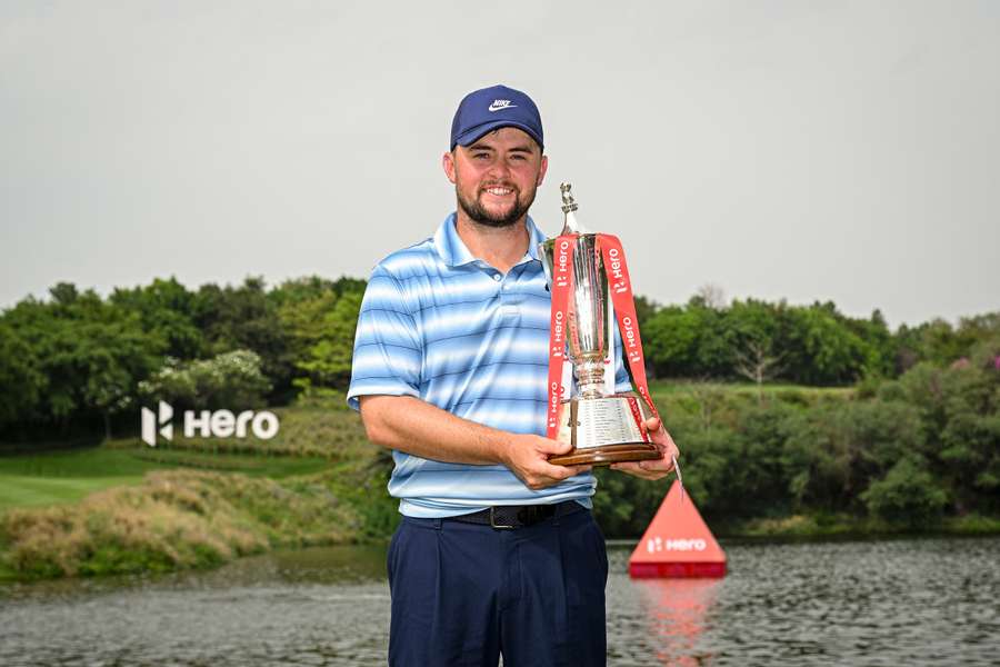 Alex Fitzpatrick poses with the trophy following victory on day four of the Indian Open